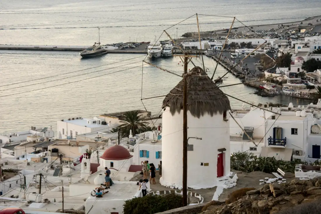 Seaside dining setup with seafood and wine in the Greek islands.